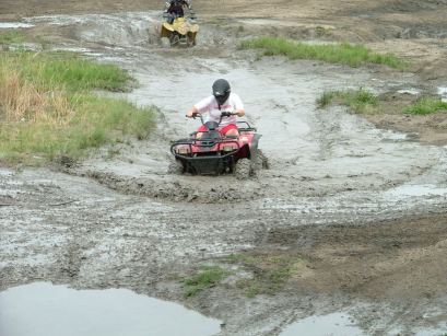 Red Rustler 260 xl half way through mud