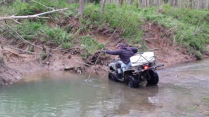 ATV navigating a deep muddy river